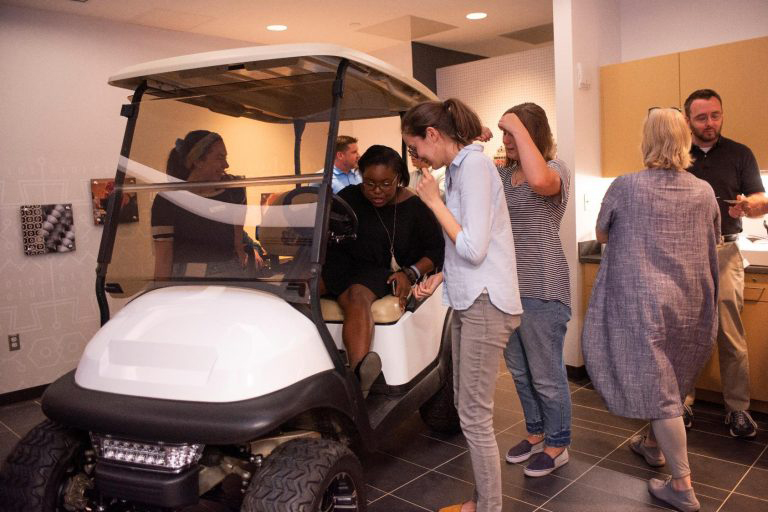 An upfitted golf cart that’s custom designed to haul large projects and materials – also made an appearance inside the new studio during the space’s unveiling. 