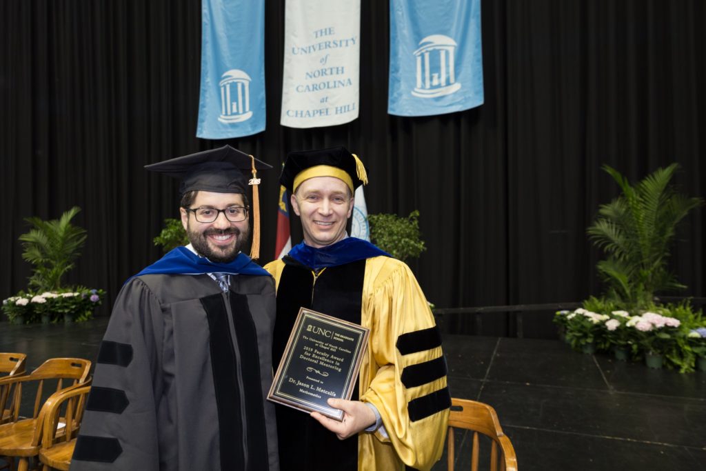 Jason Metcalfe (right), mathematics professor, received the 2019 Faculty Award for Excellence in Doctoral Mentoring. He is pictured with Robert Booth, who received his doctoral degree in mathematics in August 2018 and participated in the 2019 Doctoral Hooding Ceremony. (photo by York Wilson)