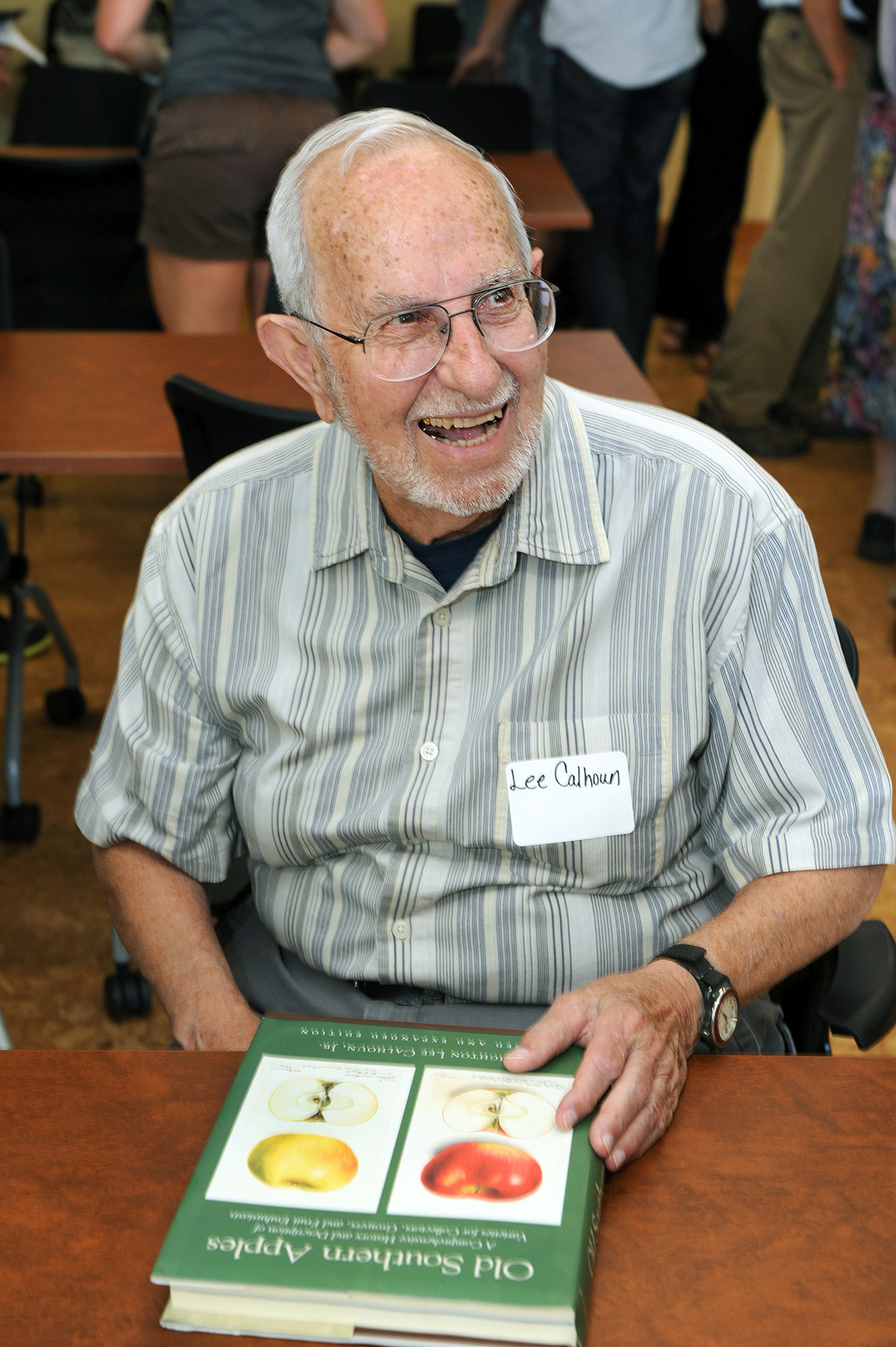 The honored guest at the celebration, Lee Calhoun, with his book on Southern apples. (photo by Donn Young)