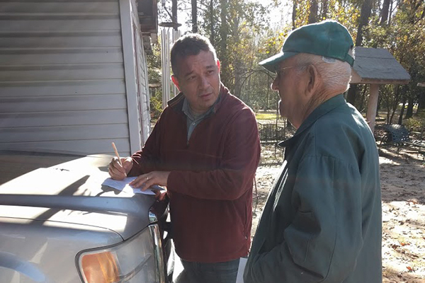 Andrew George meets one-on-one with community members to collect well water samples.