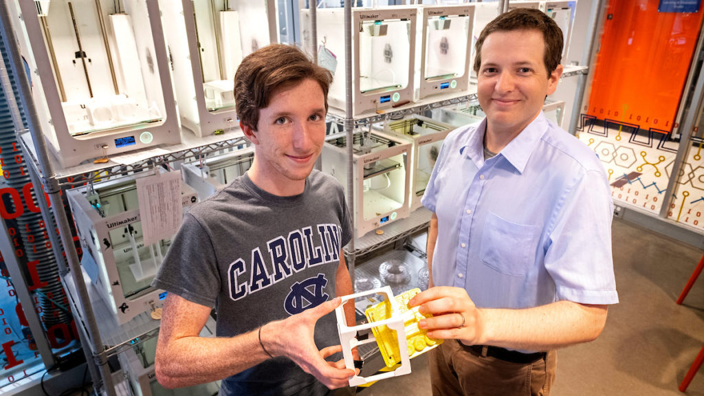 UNC student Patrick Gorman and UNC assistant professor, Andrew Mann, use 3D printers in the Murray Hall Makerspace to create models of components for small satellites. (Jon Gardiner/UNC-Chapel Hill)