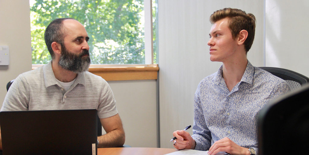 Daniel Bowen (right) meets with Ross Tompkins, assistant to the town manager, to discuss Chapel Hill's sustainability initiative.