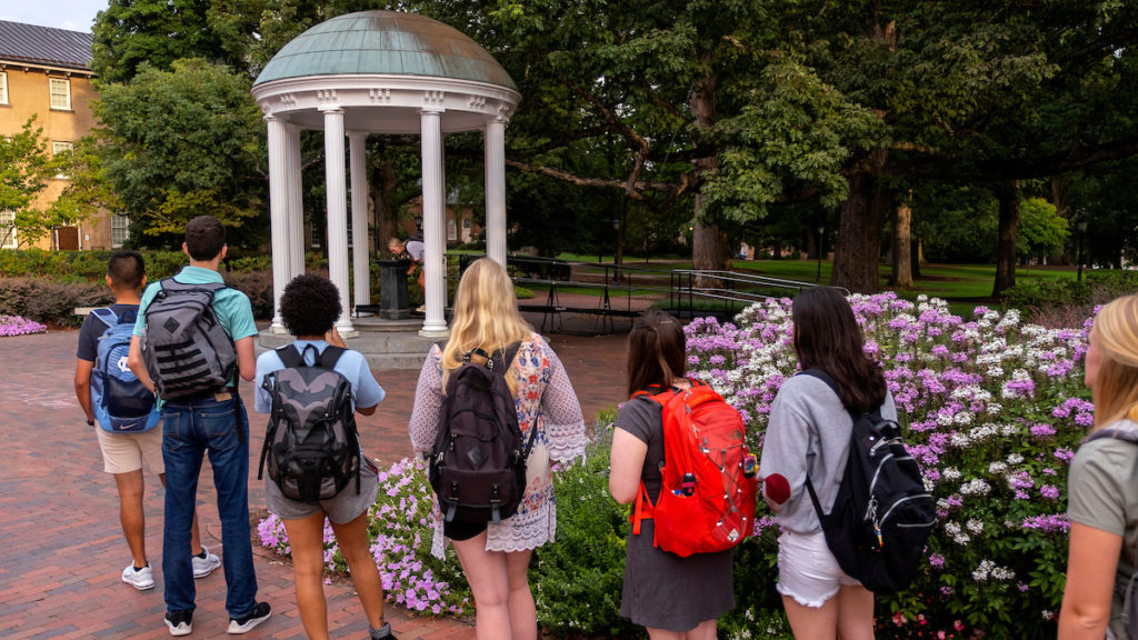 Students line up to take their first sip from the Old Well.