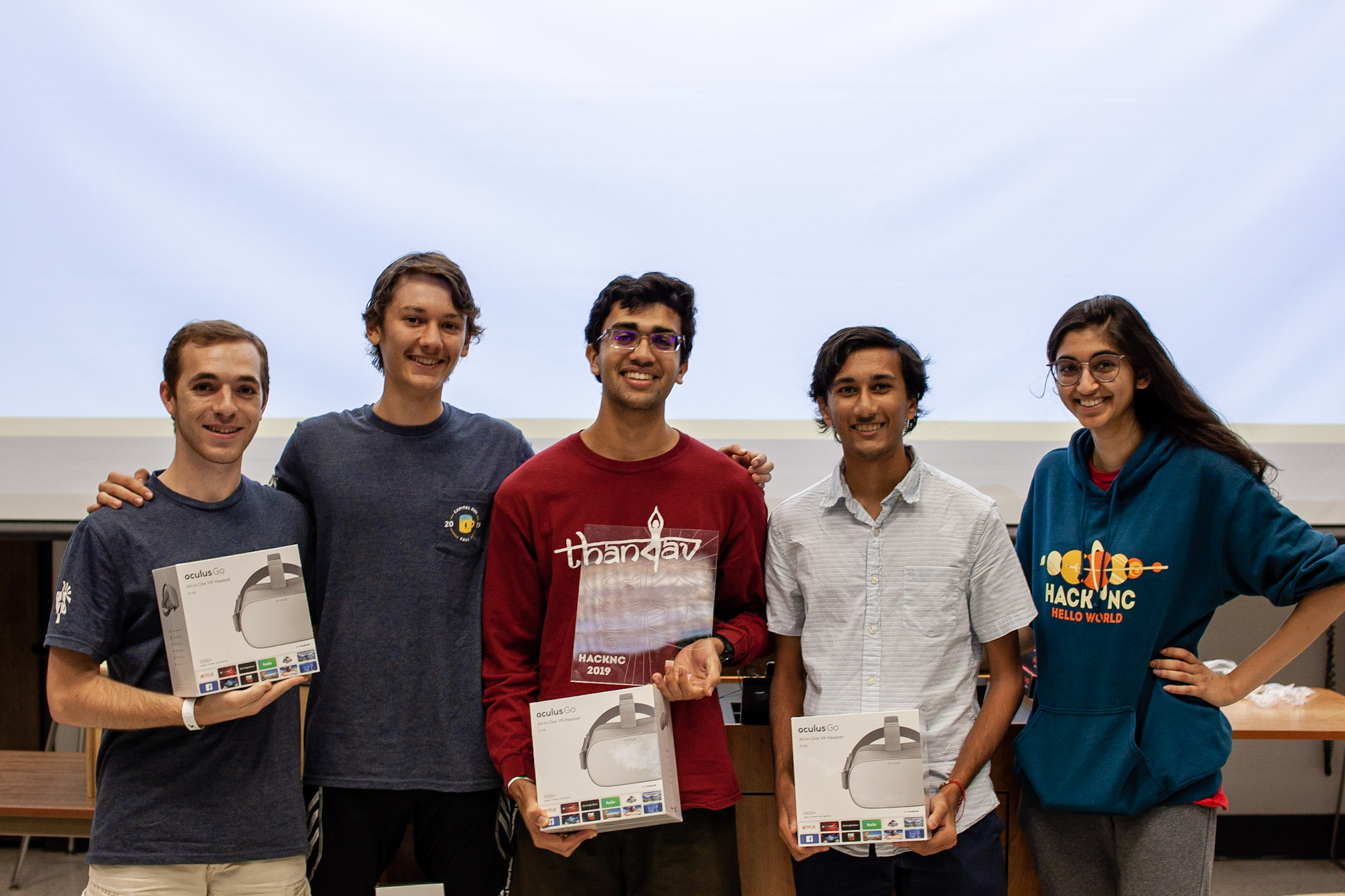 Tyler Youngberg, George Dimitrov, Vibhu Ambil and Sahil Patel accept prizes from organizer Shreya Gullapalli at HackNC 2019. (photo by Austin Wang)