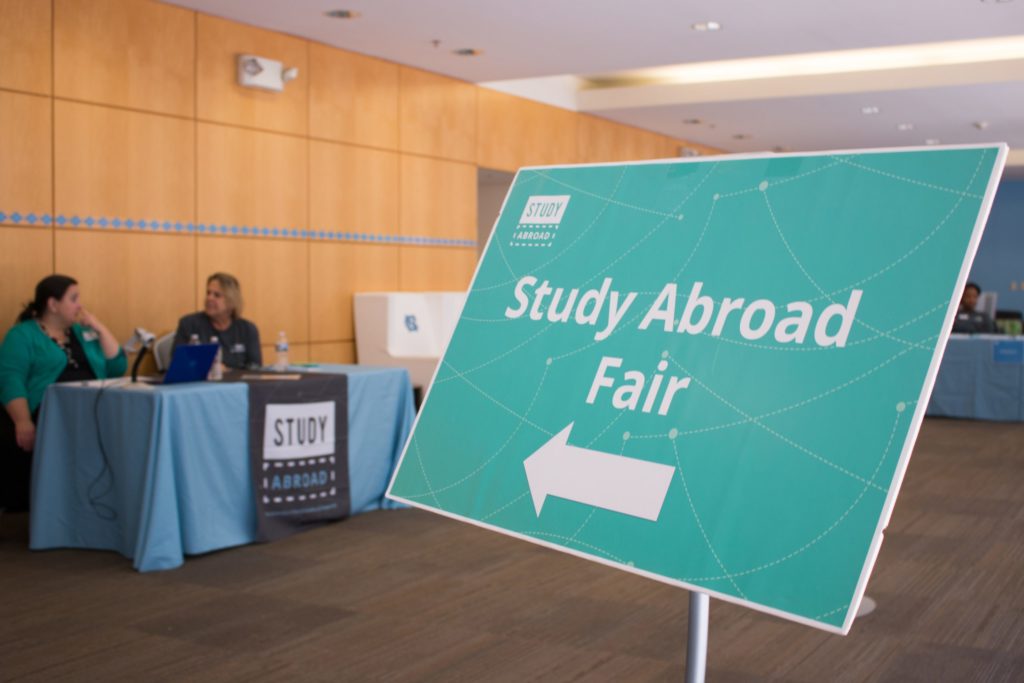 A sign points the way to global opportunities at a Study Abroad Fair on campus. (photo by Kristen Chavez)